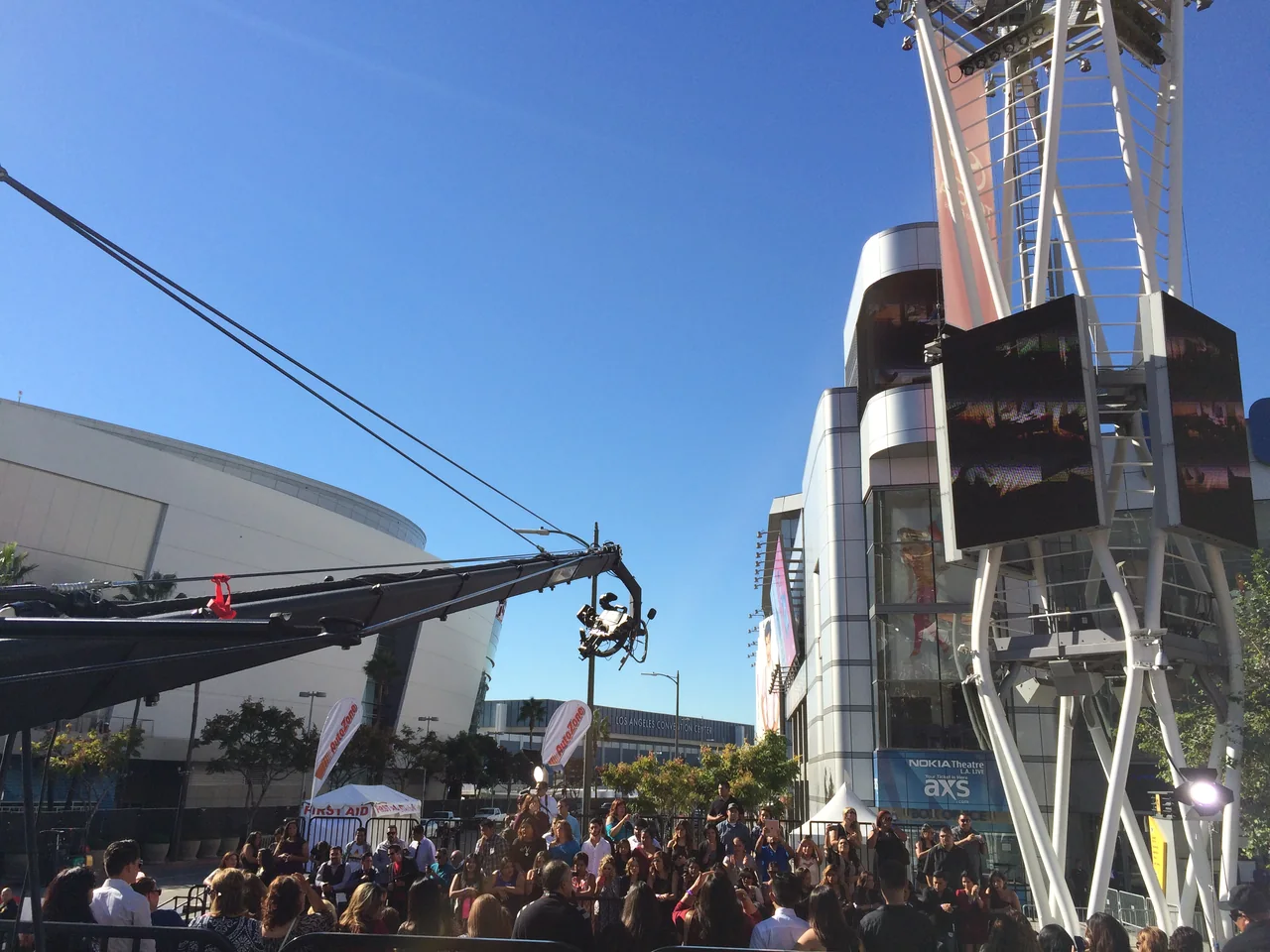 Camera crane reaching over a large outdoor audience