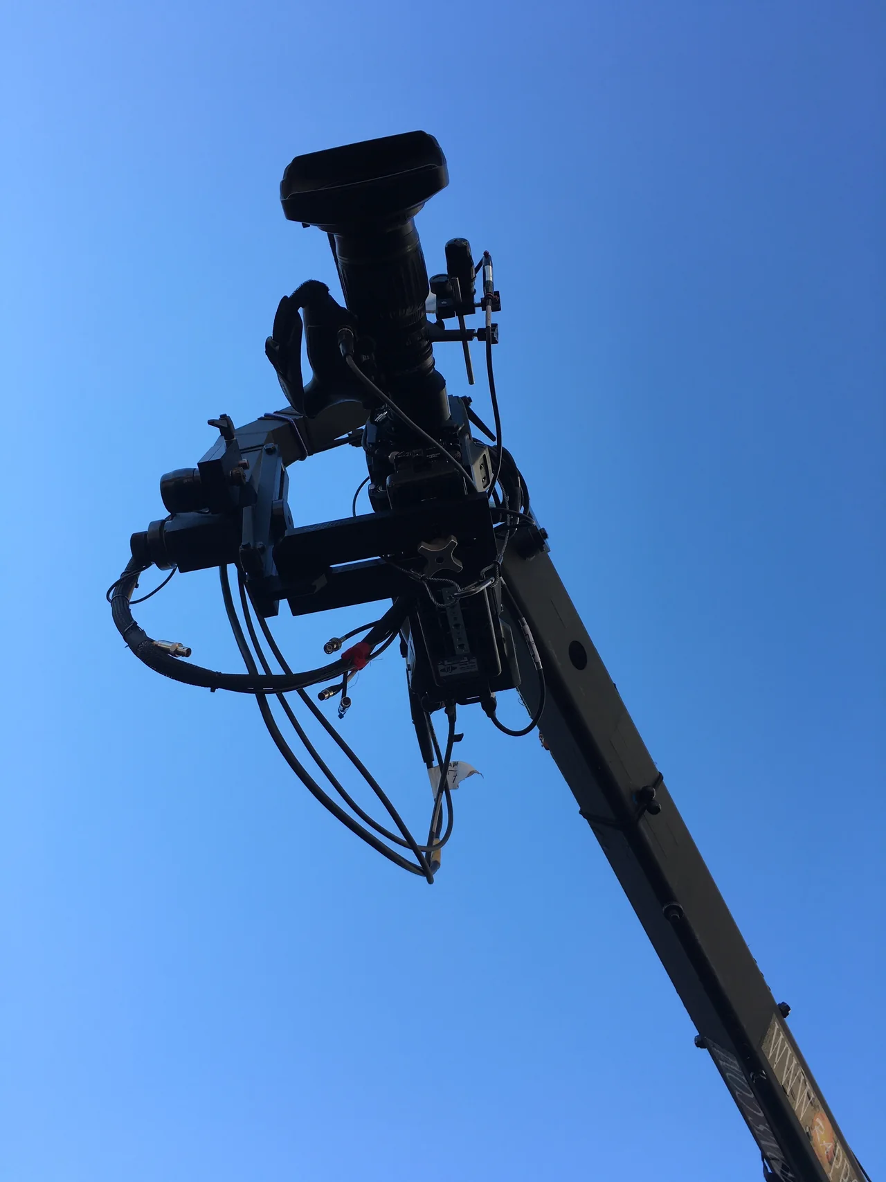 Remote camera head positioned high above an outdoor location