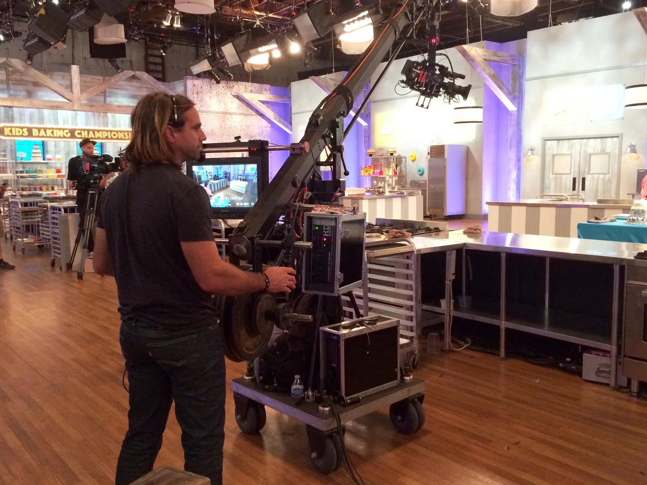 Ariel operating camera-support equipment on a television studio floor